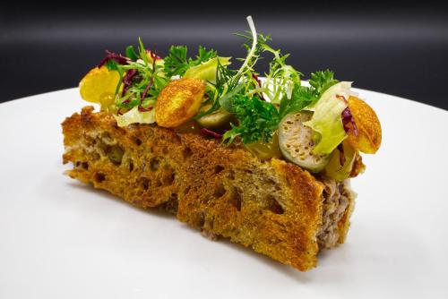 a piece of bread with a salad on top at Hotel Elfbuchen in Kassel