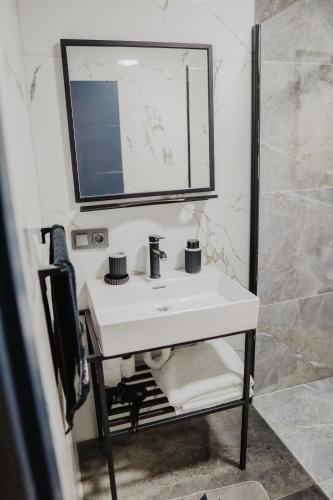 a bathroom with a white sink and a mirror at Tina Bungalov in Sapanca