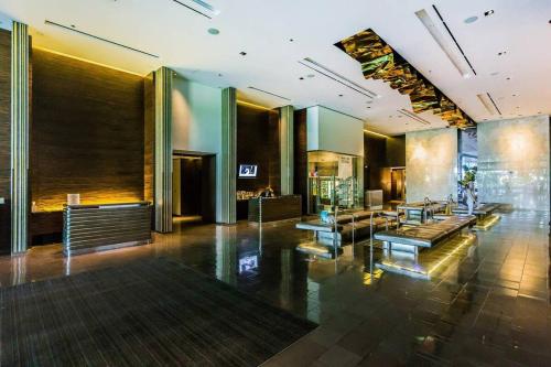 a lobby of a building with a couch and tables at Stunning Strip View Studio w BALCONY ACCESS 35308 in Las Vegas
