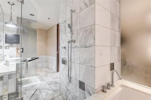 a large bathroom with a shower and a sink at Stunning Strip View Studio w BALCONY ACCESS 35308 in Las Vegas