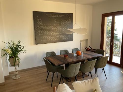 a dining room with a wooden table and chairs at Villa Perla del Sole in Baiardo