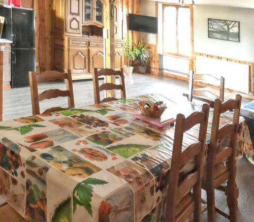 a kitchen with a table with a table cloth on it at Maison charmante à Bousson le Haut + Terrasse ensoleillée in Quarré-les-Tombes