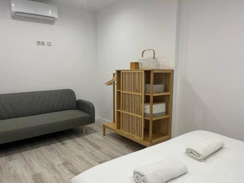 a living room with a bed and a couch at Loft San Carlos in Alicante