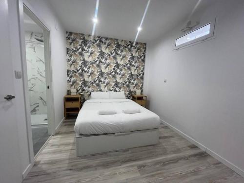 a bedroom with a bed and a wall at Loft San Carlos in Alicante