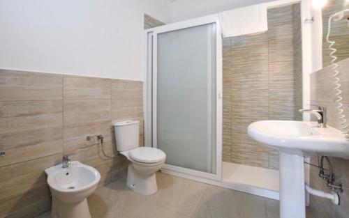 a bathroom with a toilet and a sink and a shower at Villa Rossella in Gaggi