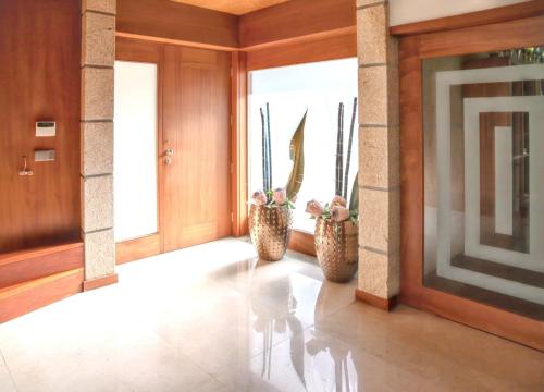 a hallway with two vases with plants in them at Spacious villa in Santo Tirso with private pool 850 m² and jacuzzi in Santo Tirso