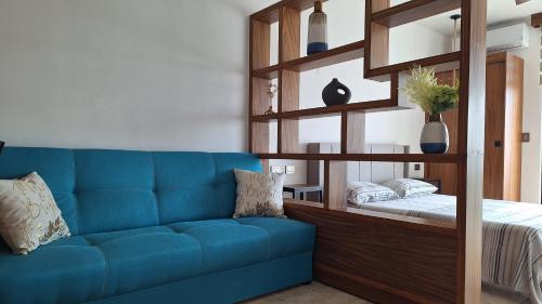 a blue couch in a room with a bed at Playa del Carmen - Playaquerida in Playa del Carmen