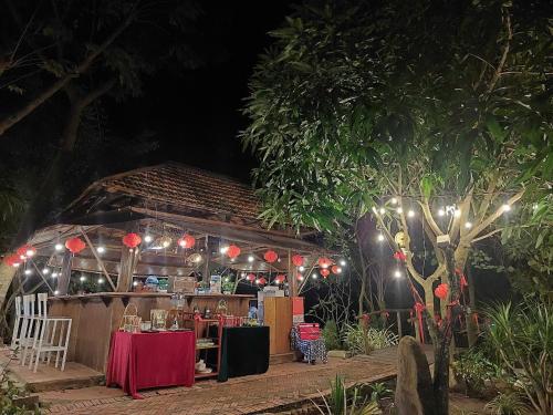 a restaurant at night with a table and lights at Lux Home Phước Hải 2 in Hội Mỹ