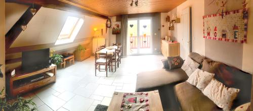un soggiorno con divano e sala da pranzo di Maison charmante avec vue sur la montagne à Triembach-au-Val a Triembach-au-Val