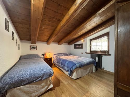 Postel nebo postele na pokoji v ubytování Chalet Il Pruno del Rosa