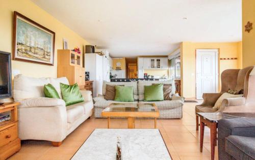 a living room with two couches and a tv at Spacious house with sea view in Liencres + jacuzzi in Liencres