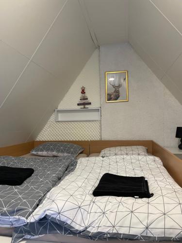 two twin beds in a room with a roof at KOTA - Prime Location in Jahorina