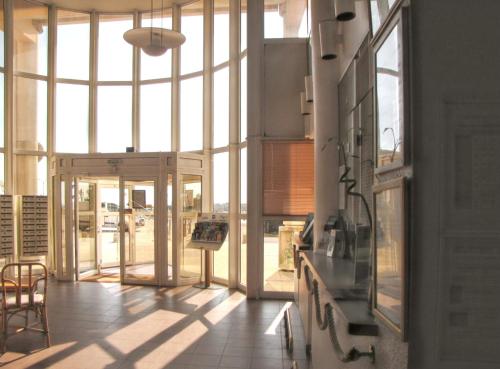 a room with a large window and a table and chairs at Charmant studio vue mer à Pornichet 30 m² avec terrasse in Pornichet