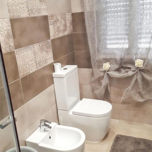 a bathroom with a toilet and a sink at Charming Villa in Fontane Bianche with Private Pool in Fontane Bianche