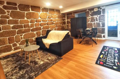 a living room with a brick wall at Charming apartment in Guimarães of 70 m² in Guimarães
