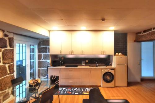 a kitchen with a stove and a refrigerator at Charming apartment in Guimarães of 70 m² in Guimarães