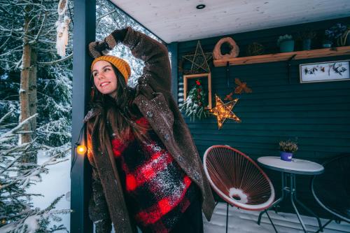 a woman dressed in a costume in a room with a fan at Gilė -'Virš Ąžuolų' - Forest SPA - Horses - Lake - Chalet in Paplatelė