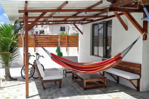 a hammock on the patio of a house at Modern apartment in Pereybère with pool view, 50 m² in Pereybere