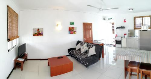 a living room with a couch and a table at Modern apartment in Pereybère with pool view, 50 m² in Pereybere
