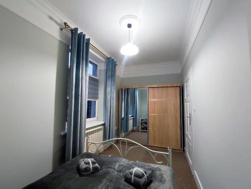 a bedroom with a bed and a hallway with a window at Apartamenty u Antka in Nowe Miasto Lubawskie