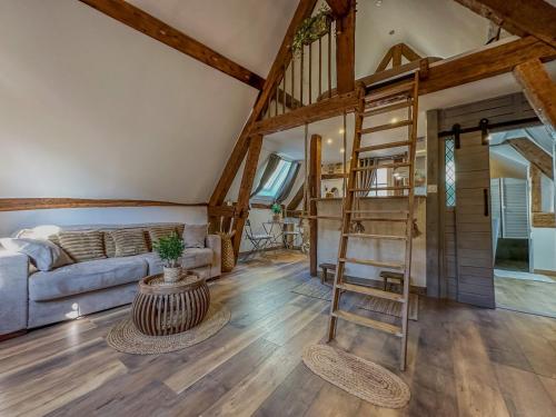 a living room with a staircase and a couch at Le Temps des Rêves in Chartres