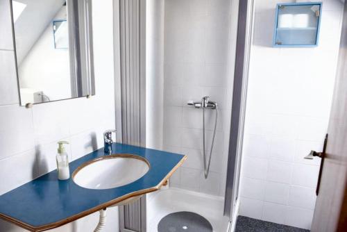 a bathroom with a sink and a shower at Cozy house in Peniche, 30 m² with sea view in Peniche