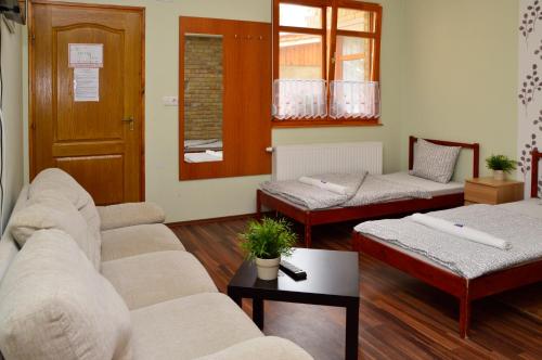 a living room with two couches and a table at Mediterrán Vendégház in Kecskemét