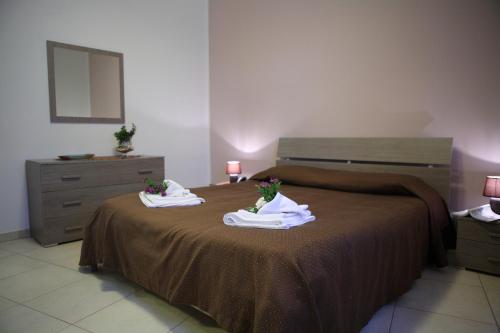 a bedroom with a bed with towels on it at Bono Vacanze Villa San Marco Luxury Holidays Homes in Sciacca