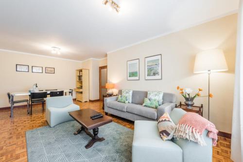 a living room with a couch and a table at GuestReady - Eclectic haven in the heart of Porto in Porto