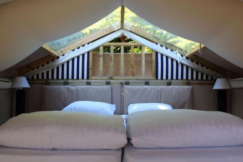 two white pillows sitting on a bed in a room at Reno Camping Village in Casal Borsetti