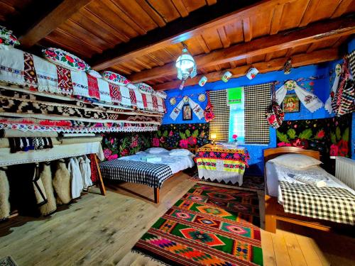 a room with two beds and a rug in a room at Pensiunea Inima Maramureșului in Breb