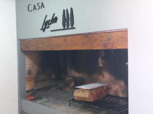 a fire place with a fireplace with some food in it at Casa Lycka in Roldán