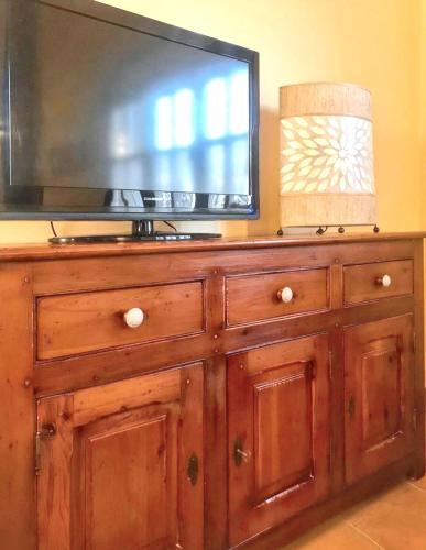 a television on top of a wooden dresser at Cozy Apartment in Ardanué with View in Ardanué