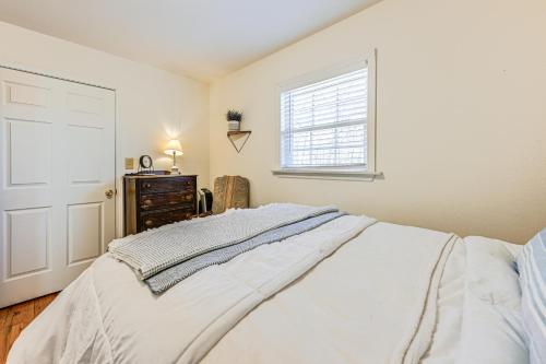 a bedroom with a white bed and a window at 8 Mi to Chattooga River Pet-Friendly Mtn Cabin in Clayton
