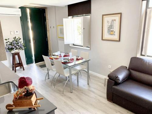a living room with a table and a couch at Cozy house in Castelo Branco, 60 m², city view balcony in Castelo Branco