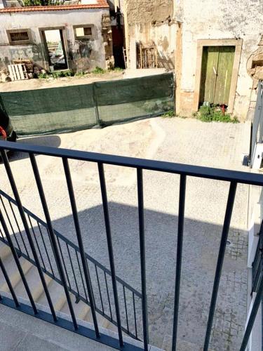 a metal railing on a balcony of a building at Cozy house in Castelo Branco, 60 m², city view balcony in Castelo Branco