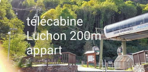 a sign that reads telephoneine luzion zoo and a train at Appartement cosy à Bagnères-de-Luchon 45 m² proche pistes de ski in Luchon