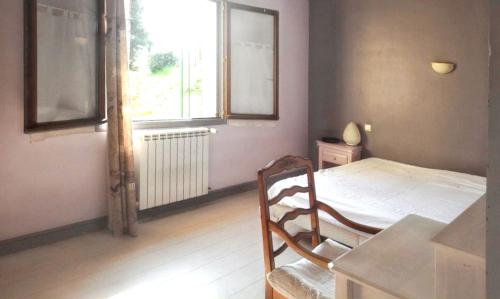 a bedroom with a bed and a window and a table at Maison confortable à Berriac, 80 m² avec jardin privé in Berriac