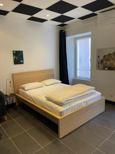 - un lit dans une chambre dotée d'un plafond en damier dans l'établissement Studio dans le centre de GAP, à Gap