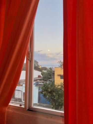 an open window with a view of a city at La Sirenita in Veracruz