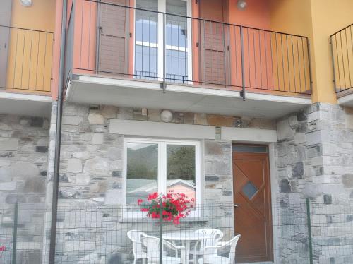 a building with a table and chairs and a window at Charming apartment in Livo 70 m² with mountain view in Livo