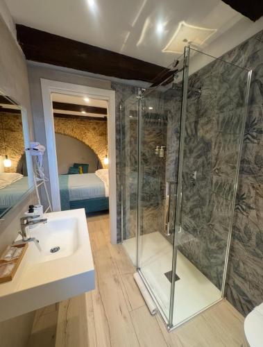 a bathroom with a shower and a sink at Arco di Pietra B&B in Crotone