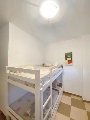 a white bunk bed in a room with a wall at Spacious apartment with mountain view in Tabernas, 99 sqm in Tabernas
