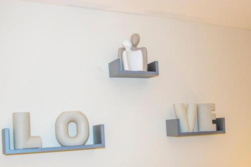 two shelves with the word love on a wall at Gym I Cinema I Hot tub I Games room at Copper Beech in Shrewsbury