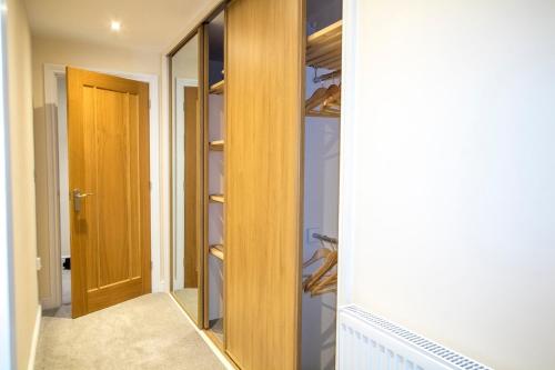 a walk in closet with a glass door at Gym I Cinema I Hot tub I Games room at Copper Beech in Shrewsbury