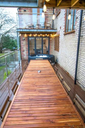a wooden boardwalk in the middle of a building at Gym I Cinema I Hot tub I Games room at Copper Beech in Shrewsbury