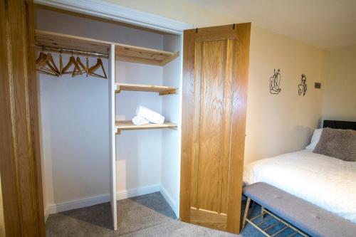 a bedroom with a bunk bed and a ladder to a bed at Gym I Cinema I Hot tub I Games room at Copper Beech in Shrewsbury