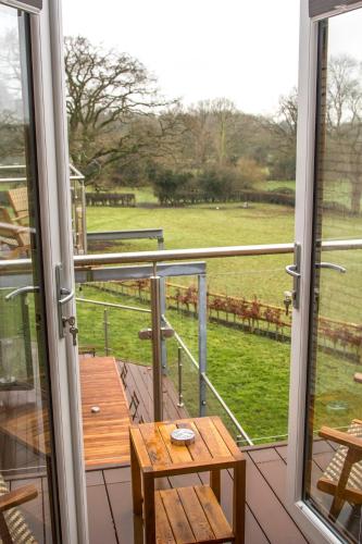 a balcony with a table and a view of a field at Gym I Cinema I Hot tub I Games room at Copper Beech in Shrewsbury