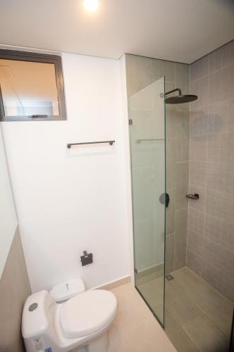 a bathroom with a toilet and a glass shower at Exclusive condo with spectacular SEA VIEW! in Santa Marta