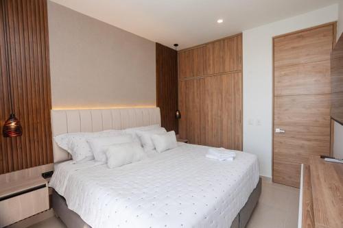 a bedroom with a white bed and a television at Exclusive condo with spectacular SEA VIEW! in Santa Marta